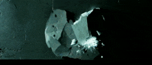 a black and white image of a person breaking a glass