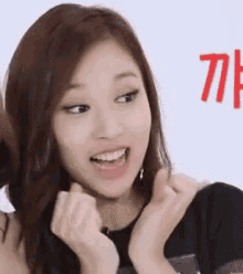 a close up of a woman making a funny face with her hands .