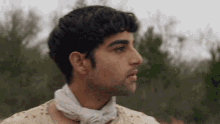 a man with a white bandana around his neck