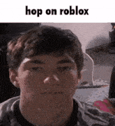 a close up of a young man 's face with the words `` hop on roblox '' written above it .