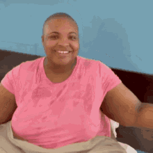 a woman in a pink shirt is clapping her hands