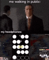 a man in a suit and tie is walking in public with headphones on .