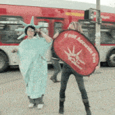 a woman in a statue of liberty costume is holding a fast accurate fun banner