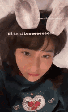 a girl wearing bunny ears has a caption that says niteniteeeee