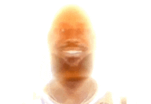 a blurry picture of a man with a beard and a white shirt