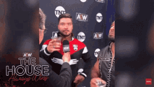 a man is being interviewed in front of a wall that says aew
