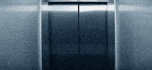 a stainless steel elevator door is open and empty