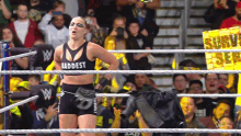 a woman in a wrestling ring wearing a baddest tank top