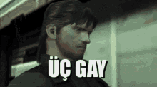a man with a beard is standing in front of a building and says üç gay