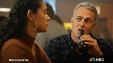 Gives The Bottle Of Beer Kelly Severide GIF - Gives The Bottle Of Beer Kelly Severide Stella Kidd GIFs