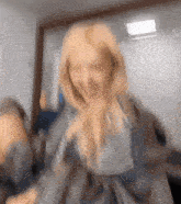 a blurry picture of a woman making a funny face