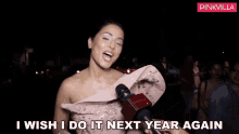 a woman talking into a microphone with the words i wish i do it next year again