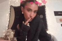 a woman with hearts in her hair is making a funny face