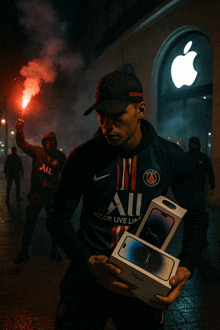 a man wearing a shirt that says accor live limit holds two iphones