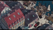 an aerial view of a harbor with boats and trucks in it