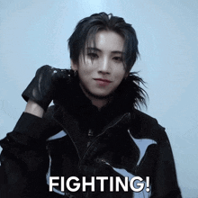 a man wearing a black jacket says fighting