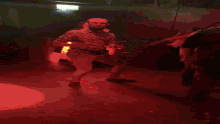 a blurred image of a man dancing with a purple light behind him