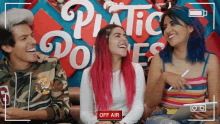 a group of people are laughing in front of a sign that says plastic bones