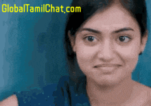 a close up of a woman 's face with a global tamilchat.com logo in the corner