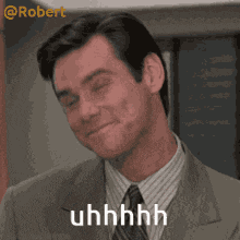 a man in a suit and tie is smiling and saying uhhhhh