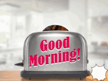 a silver toaster says good morning in red letters