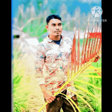 a man is standing in a field holding a red rake