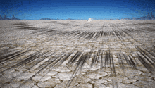 a desert landscape with mountains in the background and a blue sky