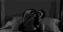a black and white photo of a man and woman hugging