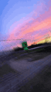 a blurry picture of a green sign that says ' e '