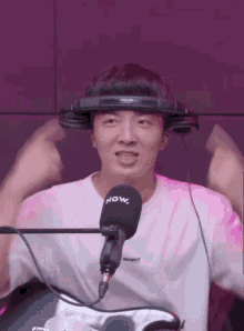 a young man wearing headphones and a now microphone