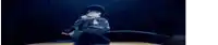a person is holding a microphone in their hand in the dark .
