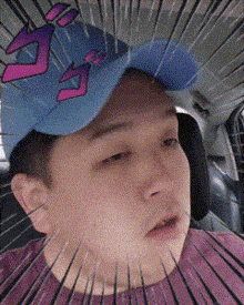 a man wearing a blue hat with the letter g on it is sitting in a car .