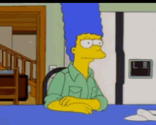a cartoon of marge simpson sits at a table with her arms crossed