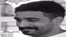 a black and white photo of a man with a beard and nose ring