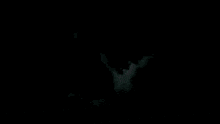 a blue light is coming out of a black background