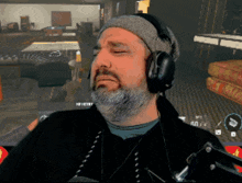 a man with a beard wears headphones and a hat