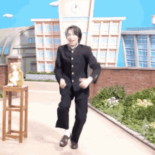 a man in a school uniform is dancing in front of a large clock