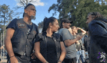 a man wearing a black vest with a patch that says eagle on it
