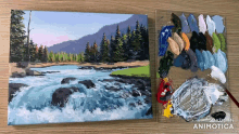 a painting of a river next to a palette with the words made in animatica on the bottom