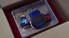 a blue toy in a box that says ' toys ' on it
