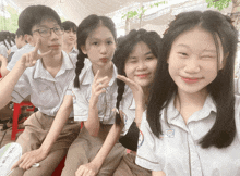 a group of students are posing for a picture with one girl wearing a shirt that says ' eee ' on it