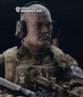 a bald soldier wearing headphones and holding a rifle ..