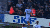 a soccer player with the number 11 on his jersey is running towards the goal