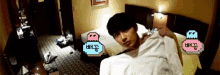 a man is laying on a bed with a pink and blue sticker that says ' a ' on it