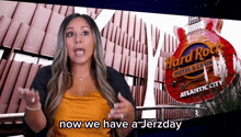 a woman is standing in front of a hard rock hotel and casino sign