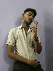 a man in a white shirt is holding a butterfly in his hand