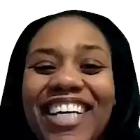a close up of a woman 's face with a hood on and a big smile .