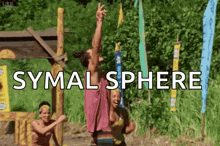 a group of people are playing volleyball in a field with the words symal sphere written on the screen .