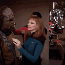 Putting A Party Hat Worf GIF - Putting A Party Hat Worf Deanna Troi GIFs