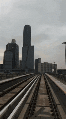 a view of a city from the train tracks
